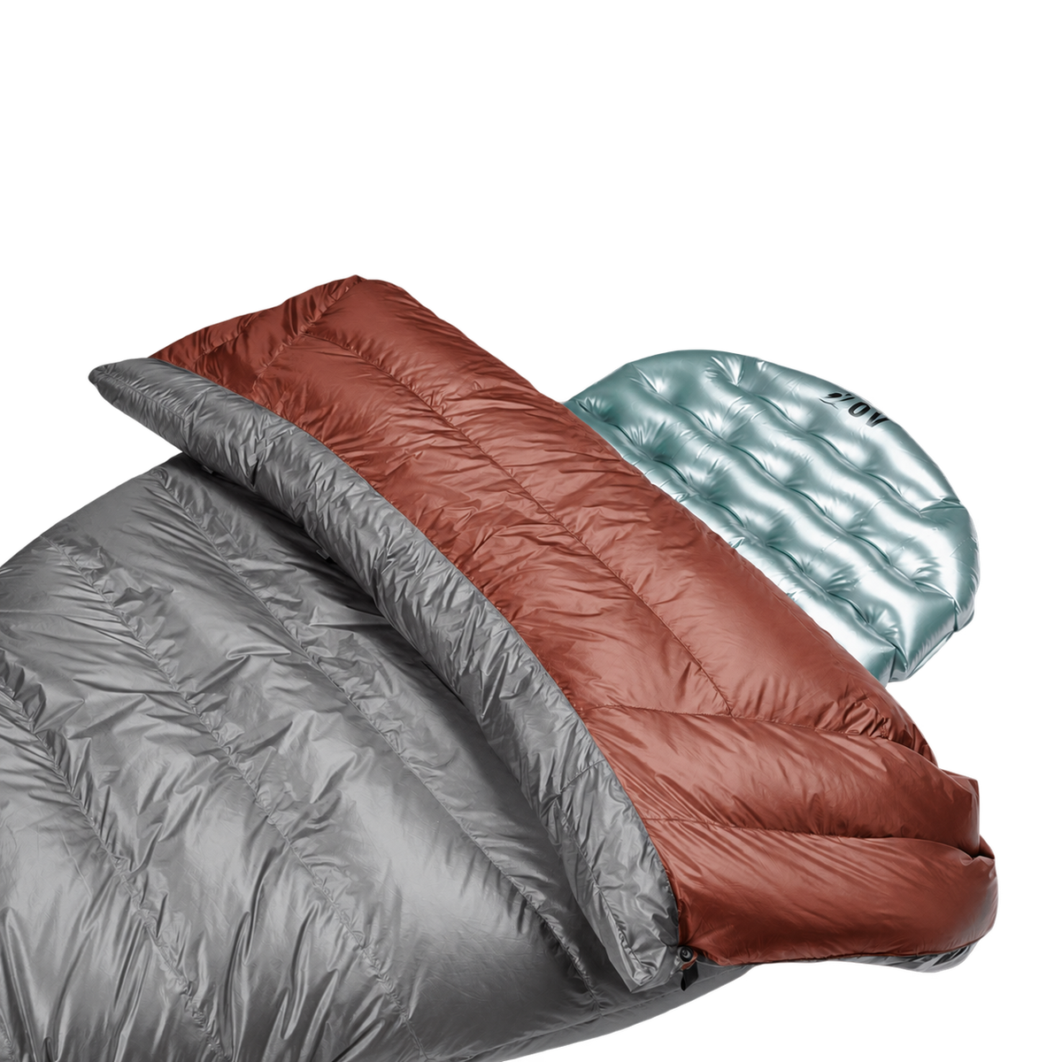 Close-up view of the red Outdoor Vitals StormLoft Down TopQuilt pulled down to reveal its soft inner lining, paired with an inflatable sleeping pad setup.