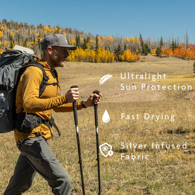 Golden - hiker wearing sun hoodie while hiking across autumn meadow