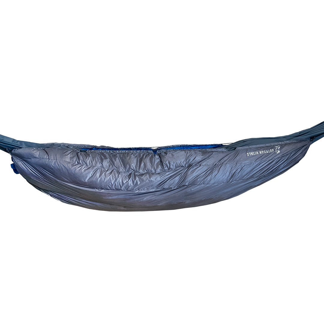 Full side view of the Outdoor Vitals StormLoft 0°-30°F Down UnderQuilt fully installed and suspended under a camping hammock.