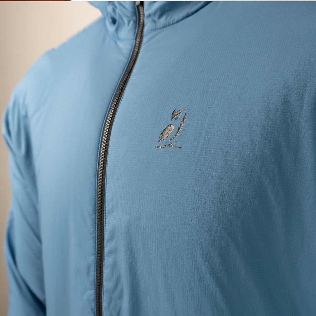 Close-up of the Outdoor Vitals Vario Jacket showing the chest logo and front zipper