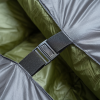 Close-up of a buckle and strap securing two sides of a backpacking quilt together.