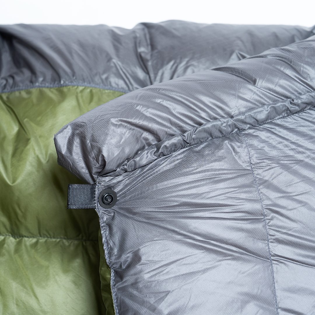 Close-up view of the top snap closure and draft collar on the Outdoor Vitals StormLoft Down TopQuilt.