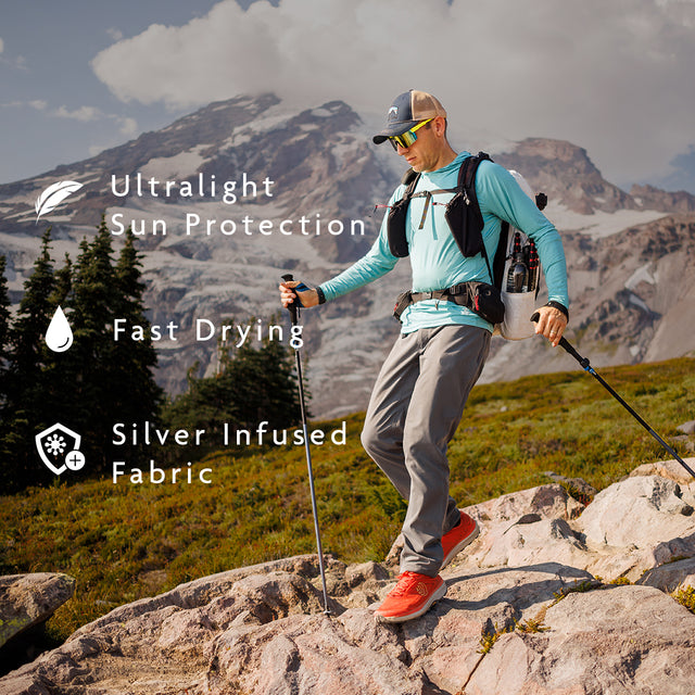 Turquoise- hiker descending rugged mountain terrain