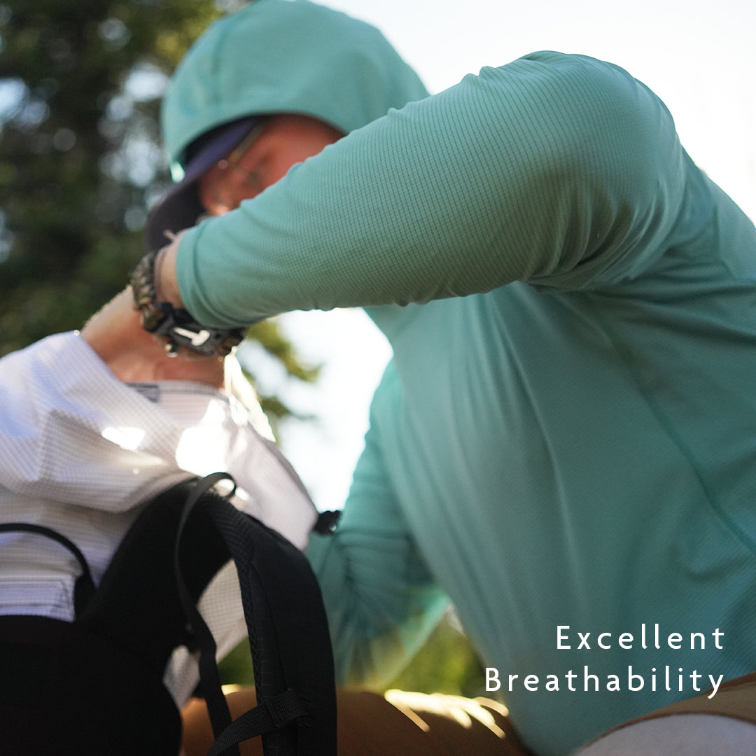 Turquoise - hiker wearing breathable sun shirt adjusting gear in backpack