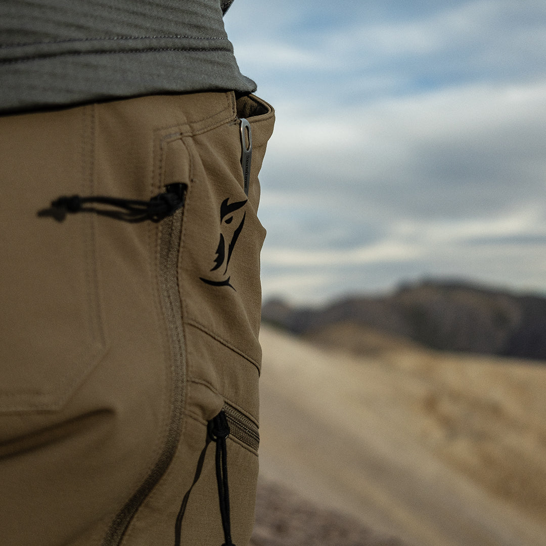 close side view of logo and pockets on men's hiking pants