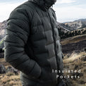Outdoor Vitals Vantage Alpine Down Jacket in with insulated hand pockets shown in use on a windy ridgeline.