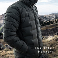 Outdoor Vitals Vantage Alpine Down Jacket in with insulated hand pockets shown in use on a windy ridgeline.
