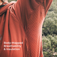 Close-up of a hooded jacket with a body-mapped perforated ventilation panel, worn outdoors with trees in the background and the text 'Body-Mapped Breathability & Insulation' overlaid on the bottom left.