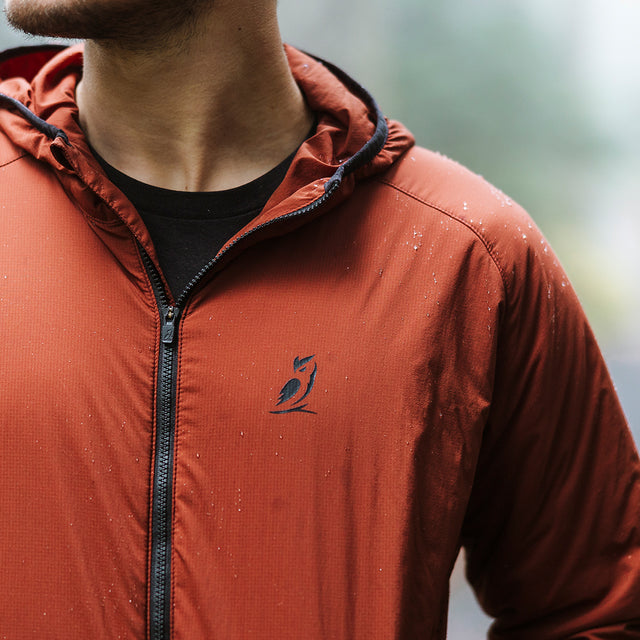 Man wearing water resistant full zip hooded jacket
