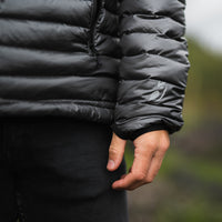 Close-up of the sleeve and logo on a NovaUL ultralight quilted down jacket.