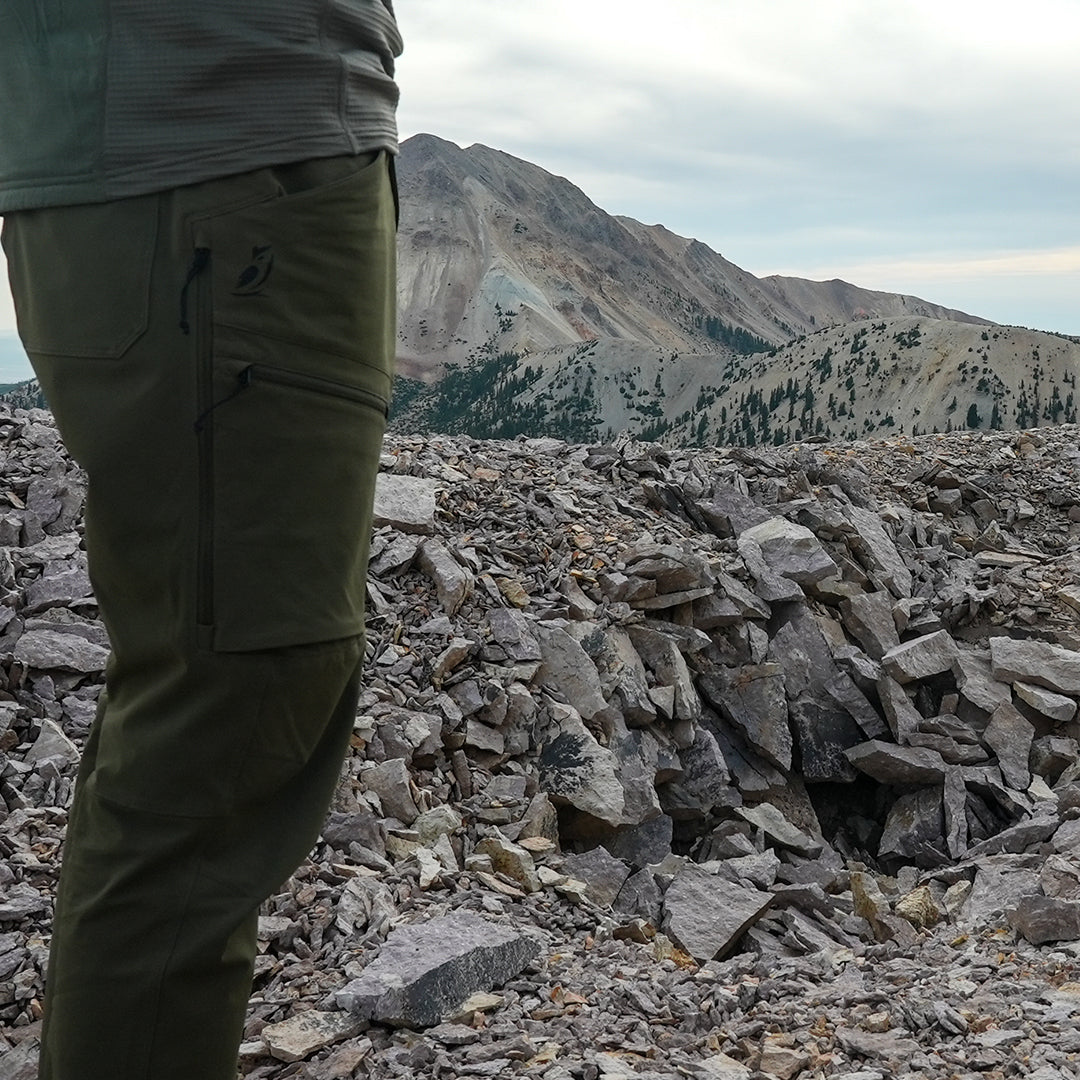 side view of men's hiking pants on rocky mountain peak
