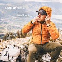 A man wearing an orange hooded puffer jacket sits outdoors on a rocky mountain slope, adjusting the hood. White text overlays read 'Seals In Heat', 'fitted hood', and 'adjustable hem', with a backpack visible at the lower left.