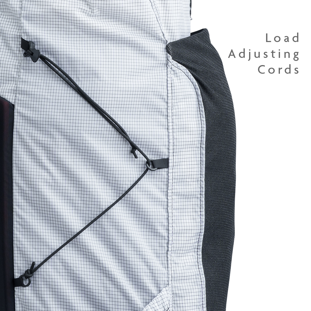 Close-up of backpack side panel showing adjustable load-compression cords.