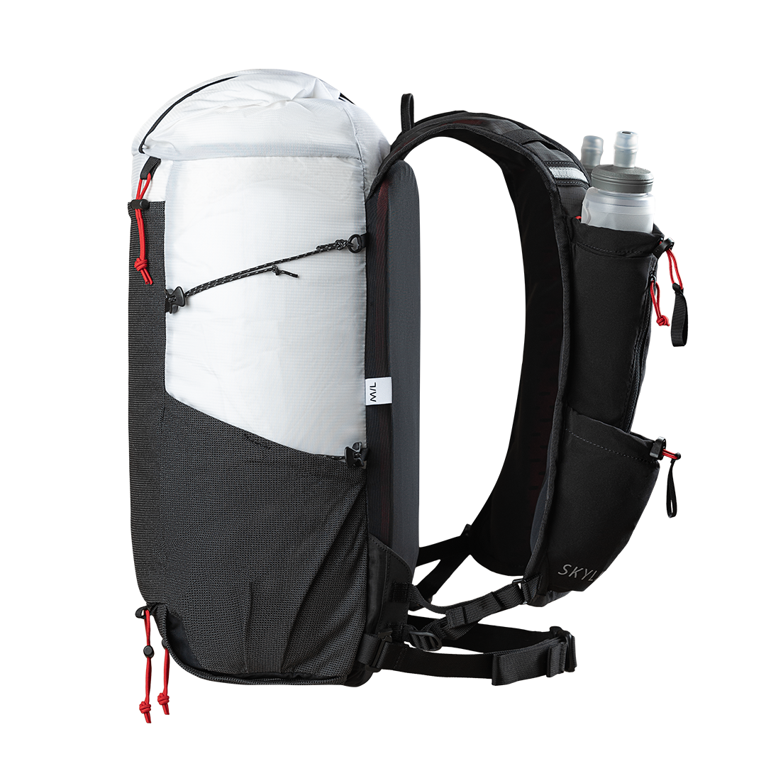 Side profile view of the Outdoor Vitals Skyline 30 Fastpack showing the vest-style harness loaded with a soft flask, side compression cords, mesh side pocket, and roll-top main compartment.