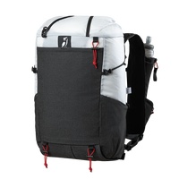 Front side view of the Outdoor Vitals Skyline 30 Fastpack highlighting the expandable front stretch-mesh pocket, side mesh pocket, top roll-closure straps, and running vest harness equipped with a water flask pocket.