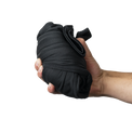 Hand holding a compact, rolled pair of Outdoor Vitals Highline Thermal Leggings.
