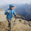 Hiker wearing the Outdoor Vitals Vario Jacket hiking across a rocky mountain summit