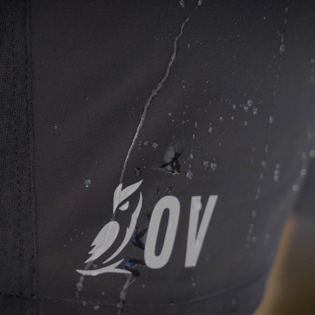 Macro shot of water beading on water-resistant Outdoor Vitals Skyline Trail Shorts with OV logo.