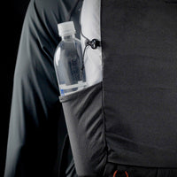 Close-up side view of the Outdoor Vitals Skyline 30 Fastpack showing a water bottle stored in the side stretch-woven pocket with cinch adjustment for secure carry.
