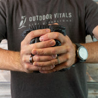 Man compressing a NovaUL jacket into a tight ball to show packability.