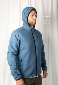Man wearing the Outdoor Vitals Vario Jacket with the hood up, front angled view