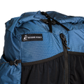 Close-up of the roll top & label on top of the Shadowlight Ultralight Backpack