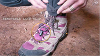 Close-up of the bottom hem of Outdoor Vitals Satu Adventure Pants, highlighting the removable lace clip feature secured to a hiking boot's laces.