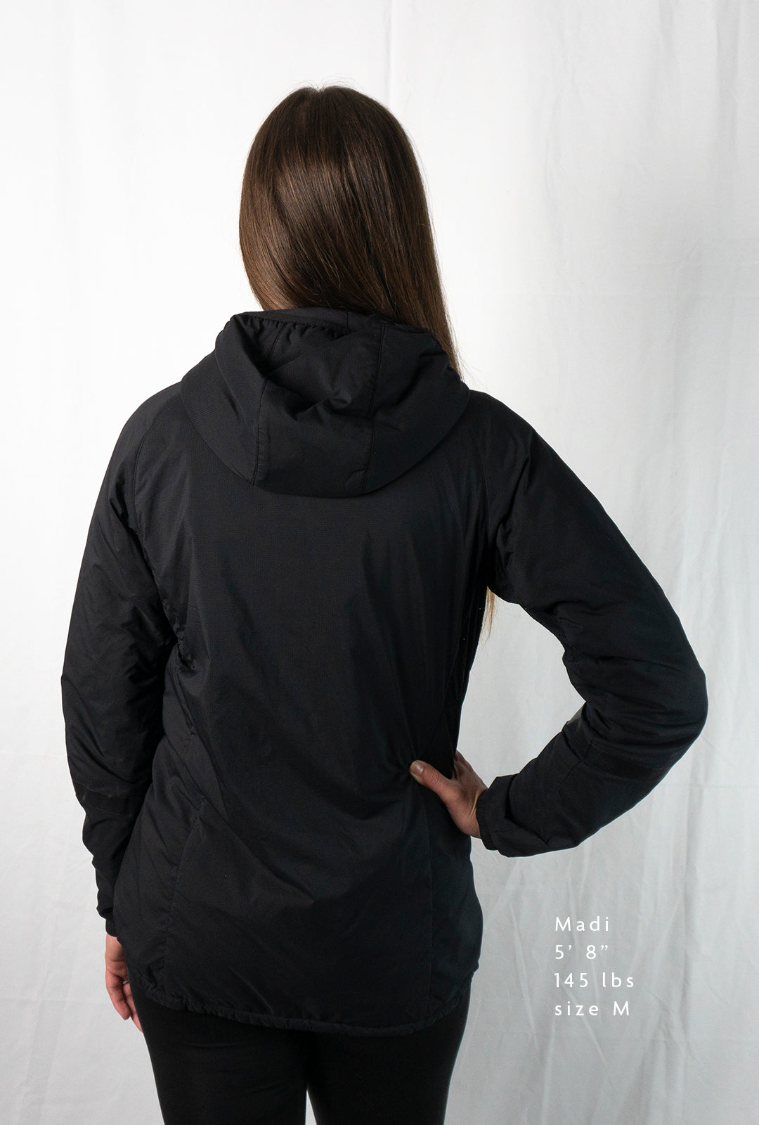Woman wearing a full zipped hoodie jacket back view
