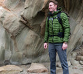 Hiker wearing Outdoor Vitals Satu Adventure Pants near rock formations.