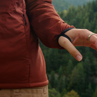 Close-up of the Outdoor Vitals Vario Jacket sleeve showing the integrated thumb loop